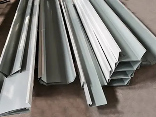 Metal cover trim component used for edge finishing and sealing in steel warehouse and workshop roof and wall cladding systems