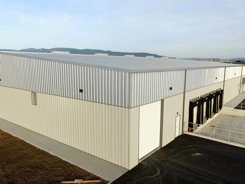 Finished metal warehouse with insulated roof and wall panels and loading dock doors