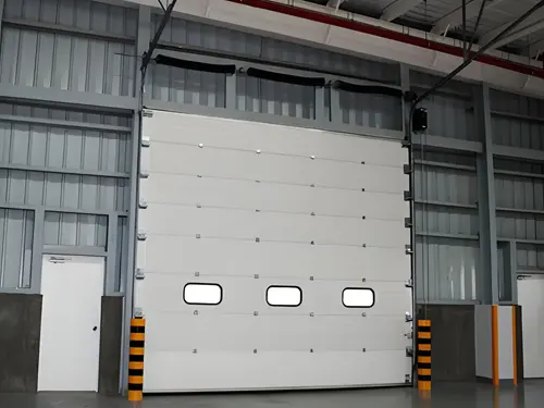 Industrial lifting door installed in a steel building for loading access and large opening entry in warehouse and workshop applications