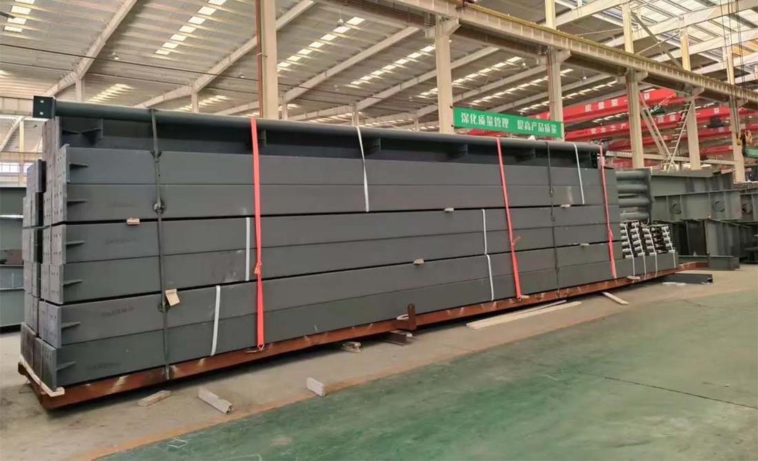Prefabricated steel workshop components are bundled, labeled, and packed securely for international shipment.