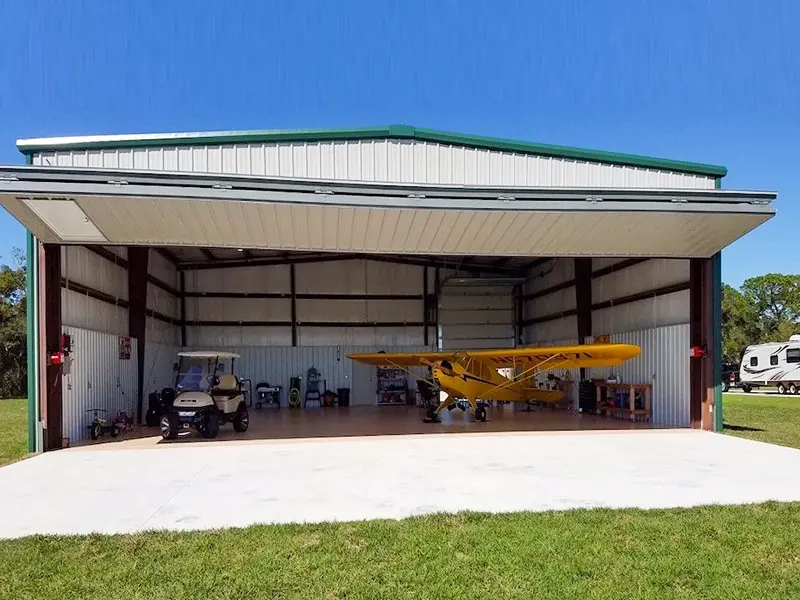 Large steel aircraft hangar with fully open front access, suitable for private planes, aviation workshops, and equipment storage.