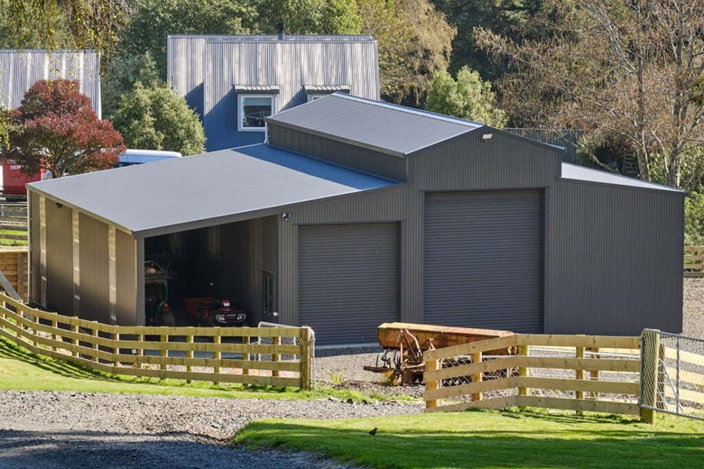 All-purpose steel barn building featuring lean-to roof extension and multiple roll-up doors, suitable for farm storage and agricultural use.