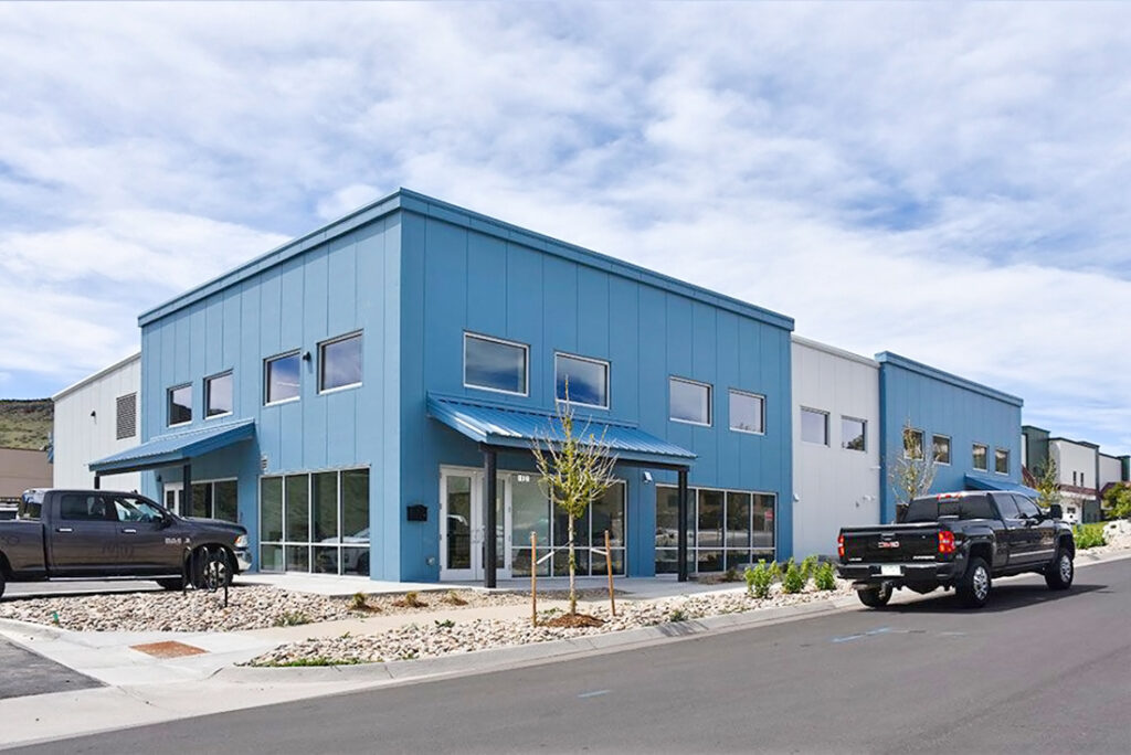 prefabricated steel office building with large windows and modern cladding