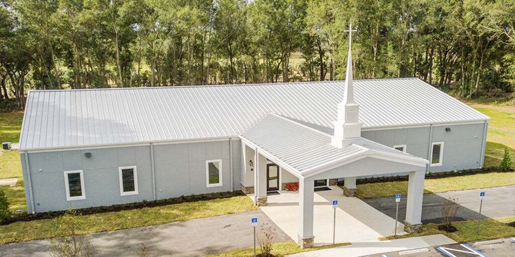Prefabricated steel church building exterior with front entrance and steeple-style façade.