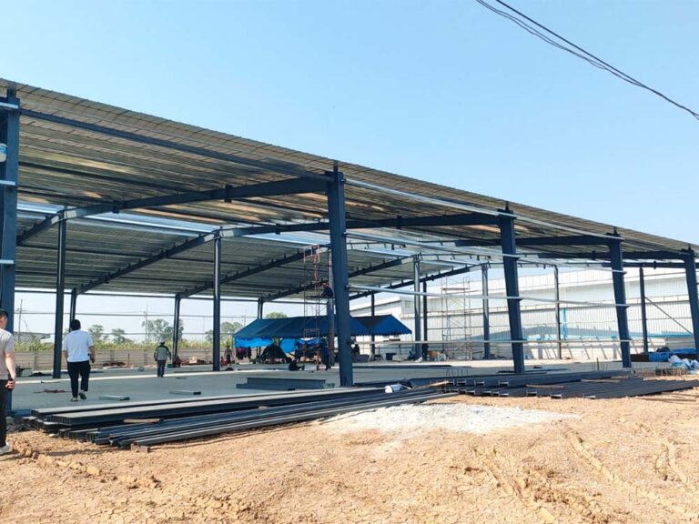 Steel portal frames and roof members being installed for a 50m × 40m steel building in Thailand