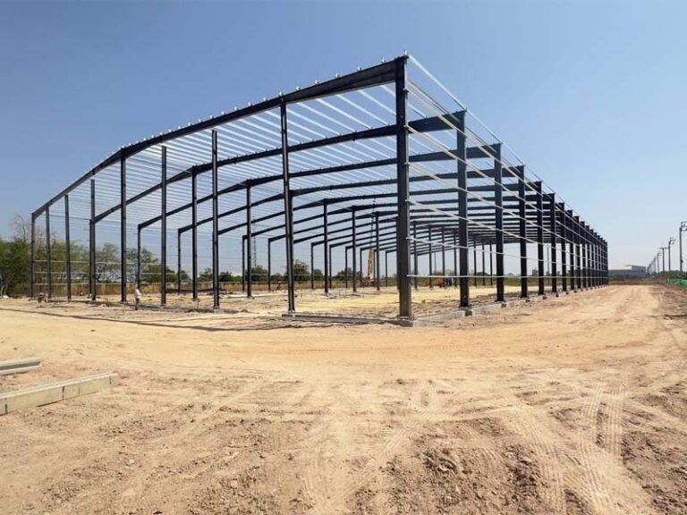 Exterior view of a large steel frame building under erection in Thailand, supplied as prefabricated steel structure