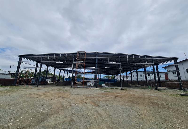 Wide overview of the steel warehouse structure on site in the Solomon Islands