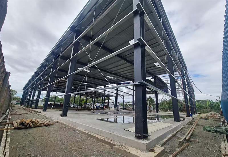 Close-up view of steel column base area during warehouse erection, Solomon Islands project