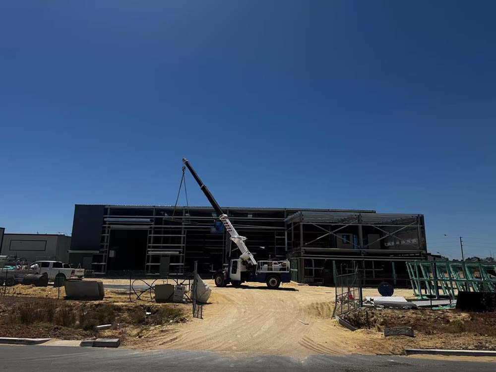 On-site construction progress showing crane operations for steel workshop and annex, Australia (2025)