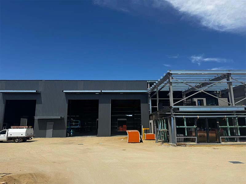 Steel workshop front view with multiple roller doors and annex connection, Australia (2025)