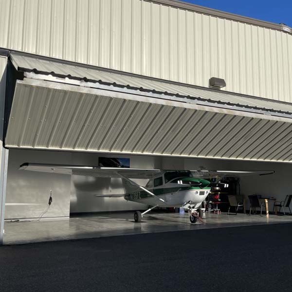 Bi-fold hangar door on a steel structure hangar for aircraft storage and maintenance