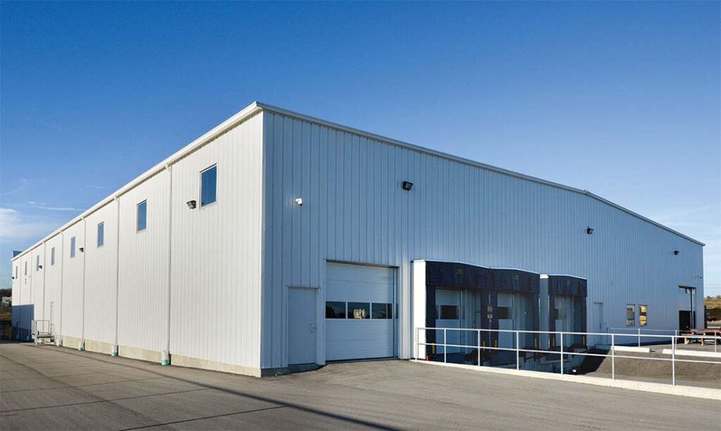Finished steel structure warehouse exterior with loading docks and metal wall panels