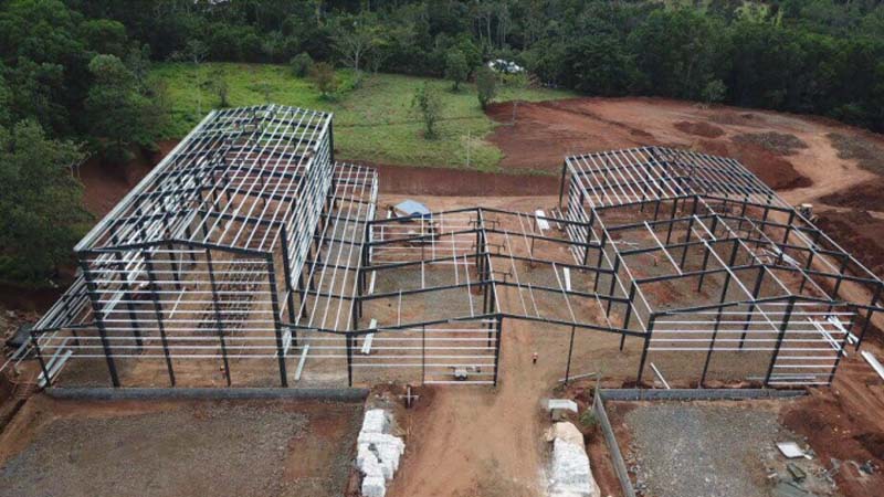 Aerial view of the multi-span steel building structure under construction for a coffee factory in Nicaragua